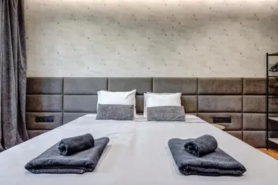 a bed with two pillows on top of it at Sophisticated 2BDRM 2BATH and Billiard in Sofia