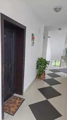 a hallway with a door and a potted plant at Studio Kasandra in Hisarya