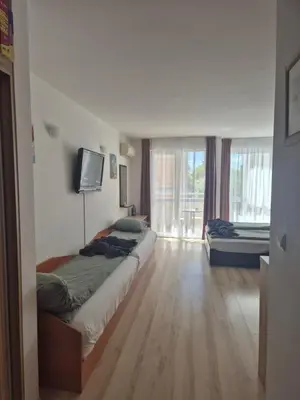 a bedroom with a bed and a television in a room at Studio Kasandra in Hisarya