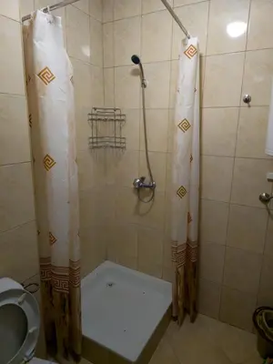 a shower with a shower curtain in a bathroom at Studio Kasandra in Hisarya