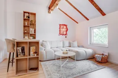 a living room with a white couch and a table at City Gem 1BDRM 200m Sofia Statue in Sofia