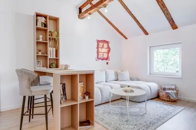 a living room with a couch and a table at City Gem 1BDRM 200m Sofia Statue in Sofia