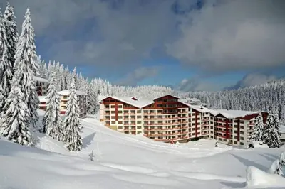 a hotel in the snow with snow covered trees at Apart Hotel Forest Nook 3 Pamporovo in Pamporovo