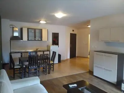 a living room and kitchen with a couch and a table at Apart Hotel Forest Nook 3 Pamporovo in Pamporovo