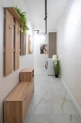 a hallway with a bench and paintings on the wall at Бизнес & Арт апартамент - до Панаира и Капана in Plovdiv