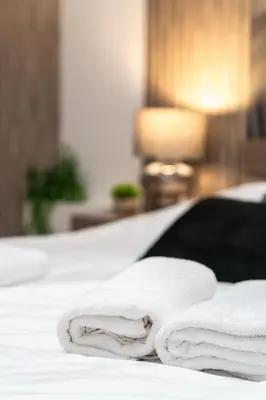 a group of towels sitting on a bed at Бизнес & Арт апартамент - до Панаира и Капана in Plovdiv
