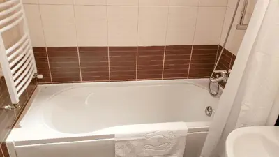 a bathroom with a white tub and a sink at Studios in Semiramida Gardens - 8,10,28 in Borovets