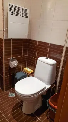a bathroom with a toilet and a air conditioner at Studios in Semiramida Gardens - 8,10,28 in Borovets