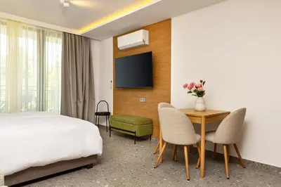 a hotel room with a bed and a table and chairs at Downtown Modern Studio with Balcony by Flat Mаnager in Plovdiv