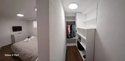 a white bedroom with a bed and a closet at Guest Suite SUZY in Petrich