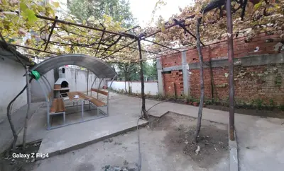 a garden with a shelter with a tree in it at Guest Suite SUZY in Petrich
