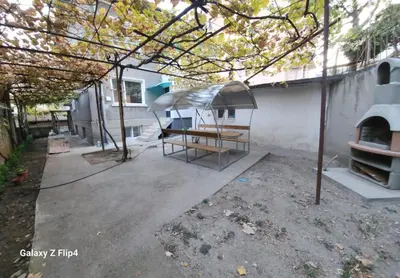 a patio with an outdoor oven in front of a house at Guest Suite SUZY in Petrich
