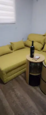 a couch sitting in a living room with a table at Guest Suite SUZY in Petrich