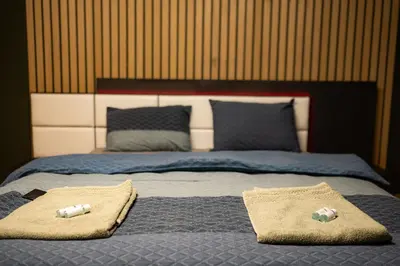 a bed with two pillows on top of it at 2 DeLuxe Apartments, Top Center Free Parking, 4 BDR in Sofia