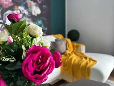 a bouquet of pink and white flowers on a table at 2BR, 4 Baths, Terrace Steps from Sofia Landmarks in Sofia
