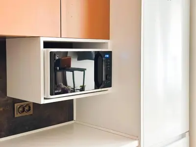a microwave hanging from a wall in a kitchen at 2BR, 4 Baths, Terrace Steps from Sofia Landmarks in Sofia
