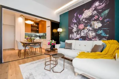 a living room with a white couch and a colorful wall at 2BR, 4 Baths, Terrace Steps from Sofia Landmarks in Sofia