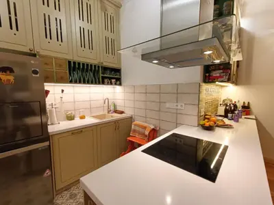 a kitchen with a white counter top and a refrigerator at Cultural Monument residence in Doktorska Gradina in Sofia