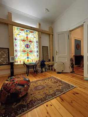 a living room with a large stained glass window at Cultural Monument residence in Doktorska Gradina in Sofia