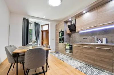 a kitchen with a dining room table and chairs at Apartment Central in Plovdiv