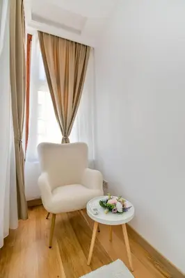 a living room with a chair and a table at Apartment Central in Plovdiv