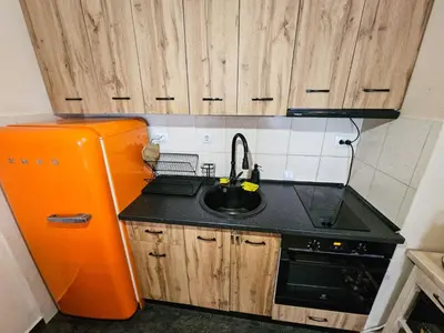 a small kitchen with a sink and an orange refrigerator at Apartment GORA in Borovets