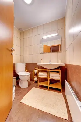 a bathroom with a sink and a toilet and a tub at Mountain Luxe Studio by Flat Manаger in Pamporovo