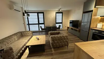 a living room with a couch and a table at Apartment Maritsa View 1 in Plovdiv