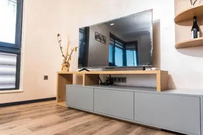 a living room with a flat screen tv on a entertainment center at Apartment Maritsa View 1 in Plovdiv