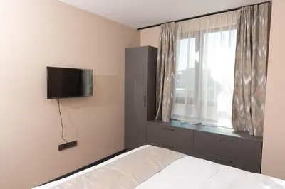 a bedroom with a bed and a television on the wall at Apartment Maritsa View 1 in Plovdiv