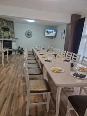 a conference room with a long table and chairs at къща за гости Рока in Mineralni Bani