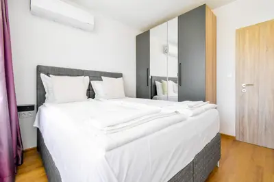 a large white bed in a room with a mirror at Contemporary City Stay by Flat Mаnager in Sofia