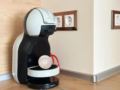 a black and white coffee maker sitting on a counter at Contemporary City Stay by Flat Mаnager in Sofia