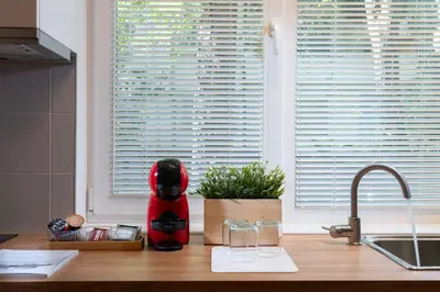 a kitchen counter with a red blender on a counter top at Starflat Gorgeous central apartment next to NDK in Sofia