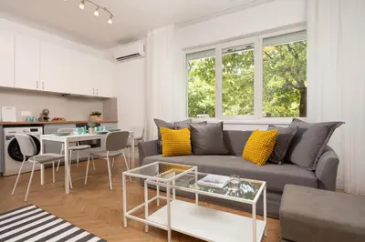 a living room with a couch and a table at Starflat Gorgeous central apartment next to NDK in Sofia