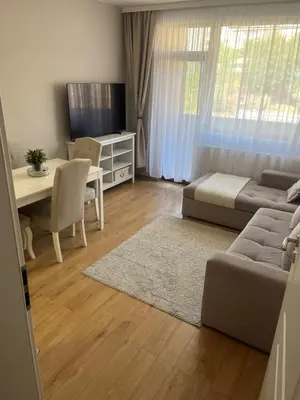 a living room with a couch and a table at Peaceful & Cozy apartment near city Center in Blagoevgrad