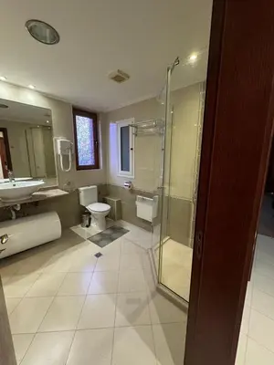 a bathroom with two toilets and a shower and a sink at Gondola Vibes in Bansko