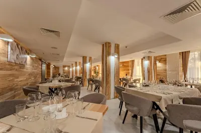 a restaurant with tables and chairs in a room at Stillaterm SPA in Mineralni Bani
