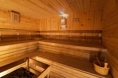 an empty wooden sauna with a bucket in it at Stillaterm SPA in Mineralni Bani