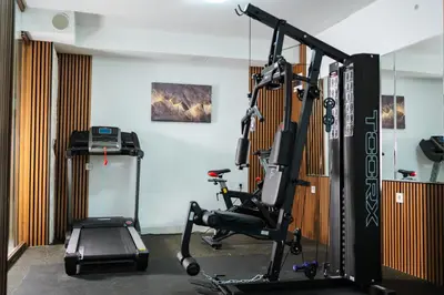a gym with a treadmill and a elliptical machine at Stillaterm SPA in Mineralni Bani