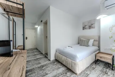 a bedroom with a bed and a flat screen tv at Stillaterm SPA in Mineralni Bani