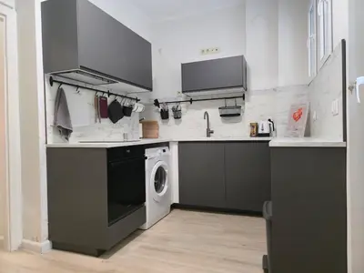 a kitchen with a washing machine and a sink at Modern 100m Apt In Sofia Center Vitosha Blvd in Sofia