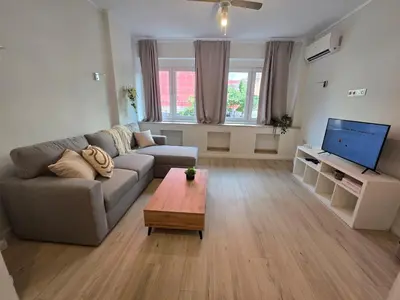 a living room with a couch and a coffee table at Modern 100m Apt In Sofia Center Vitosha Blvd in Sofia