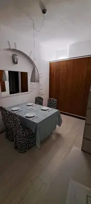 a dining room with a table and some chairs at Bright apartment in Doktorska gradina in Sofia
