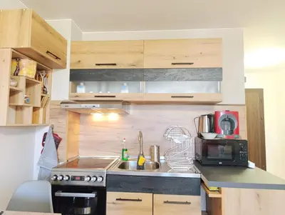 a kitchen with a sink and a microwave at Moderno Studio Park Lane in Bansko