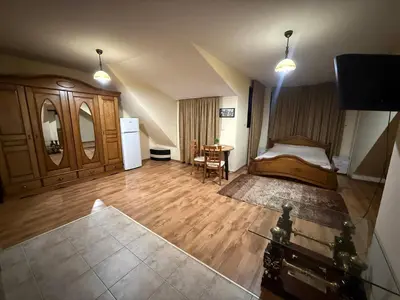 a bedroom with a bed and a desk in it at Central Mansard Studio in Sofia