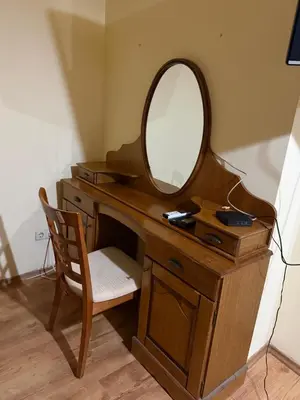 a wooden desk with a mirror and a chair at Central Mansard Studio in Sofia