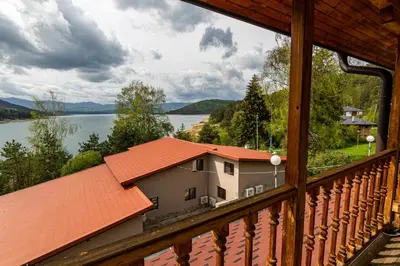 a view of a lake from a balcony of a house at Комплекс Родопска среща - Къщи и Апартаменти in Batak