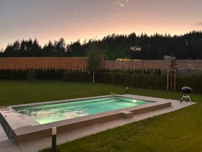 a large swimming pool in a yard with a yard at Aquaterra Villa with Hot Pool - Banya in Banya