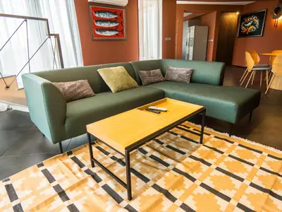 a living room with a green couch and a coffee table at Venti club B15 in Sofia